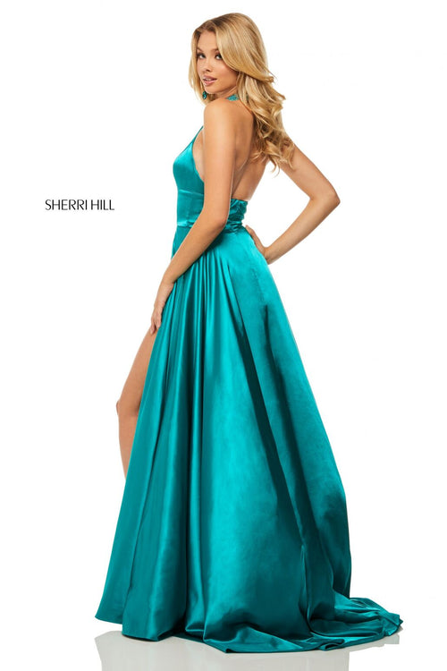 This Sherri Hill 52920 teal satin gown features a high-neck halter bodice and a side slit.