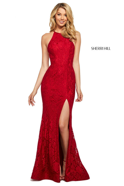 This Sherri Hill 53361 fitted stretch lace dress in red features a high cut halter style neckline and a skirt slit.