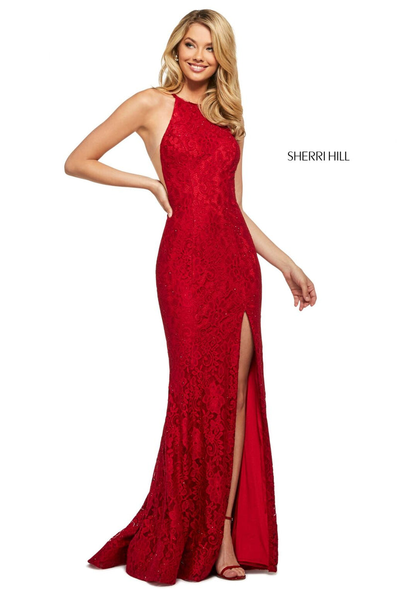 This Sherri Hill 53361 fitted stretch lace dress in red features a high cut halter style neckline and a skirt slit.