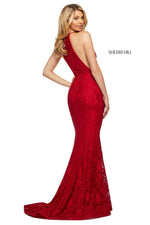 This Sherri Hill 53361 fitted stretch lace dress in red features a high cut halter style neckline and a skirt slit.