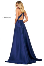 This Sherri Hill 53529 A-line satin gown in navy features a high cut halter style neckline and embellished skirt pockets. 