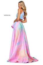 This Sherri Hill 53870 A-line dress in ivory/multi features a tie-dye print, a ruffled skirt slit, and high cut halter style neckline with a back cut out. 